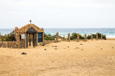 Scenic view of sea and buildings against sky