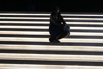 Woman sitting on staircase