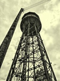 Low angle view of tower against cloudy sky