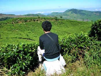 Rear view of man looking at mountain landscape