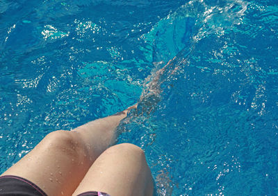 Low section of woman in swimming pool