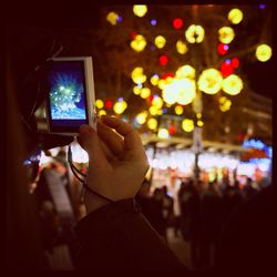 Woman standing in illuminated city at night