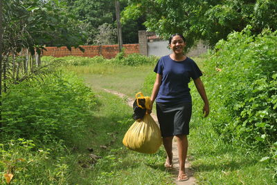 Rear view of woman standing on field