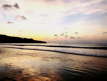 Scenic view of beach against sky during sunset