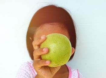 Close-up of woman holding apple