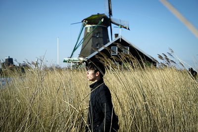 Woman standing on grassy field