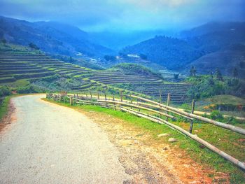 Scenic view of agricultural field against sky