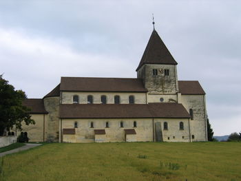 Exterior of building on field against sky