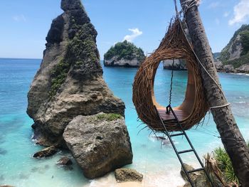 Panoramic shot of rocks by sea against sky