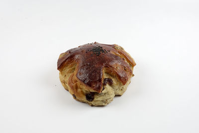 Close-up of bread over white background