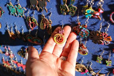 Cropped hand holding earring at market