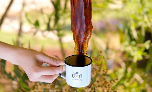 Midsection of person holding coffee cup