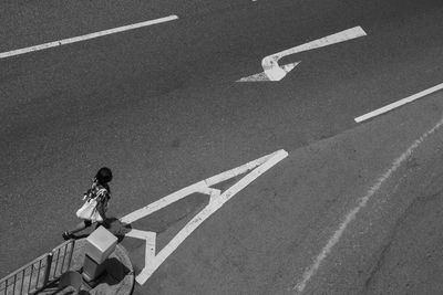 High angle view of woman crossing road