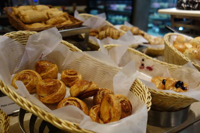 Close-up of fresh baked pastries in baskets at store