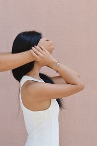 Cropped image of hands covering woman eyes