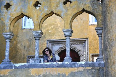 Woman leaning on railing at pena palace