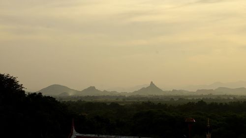 Scenic view of silhouette mountains against sky at sunset