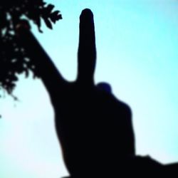 Low angle view of silhouette tree against blue sky