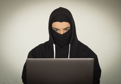 Portrait of man using smart phone against white background