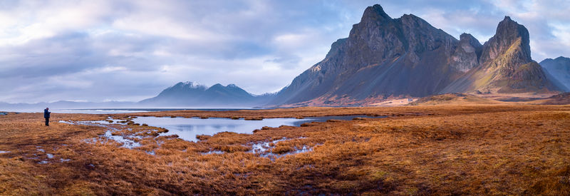 Scenic view of lake and mountains against sky