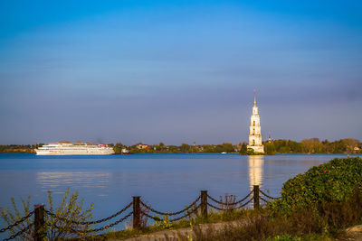 Beautiful christian church with golden domes among green trees.