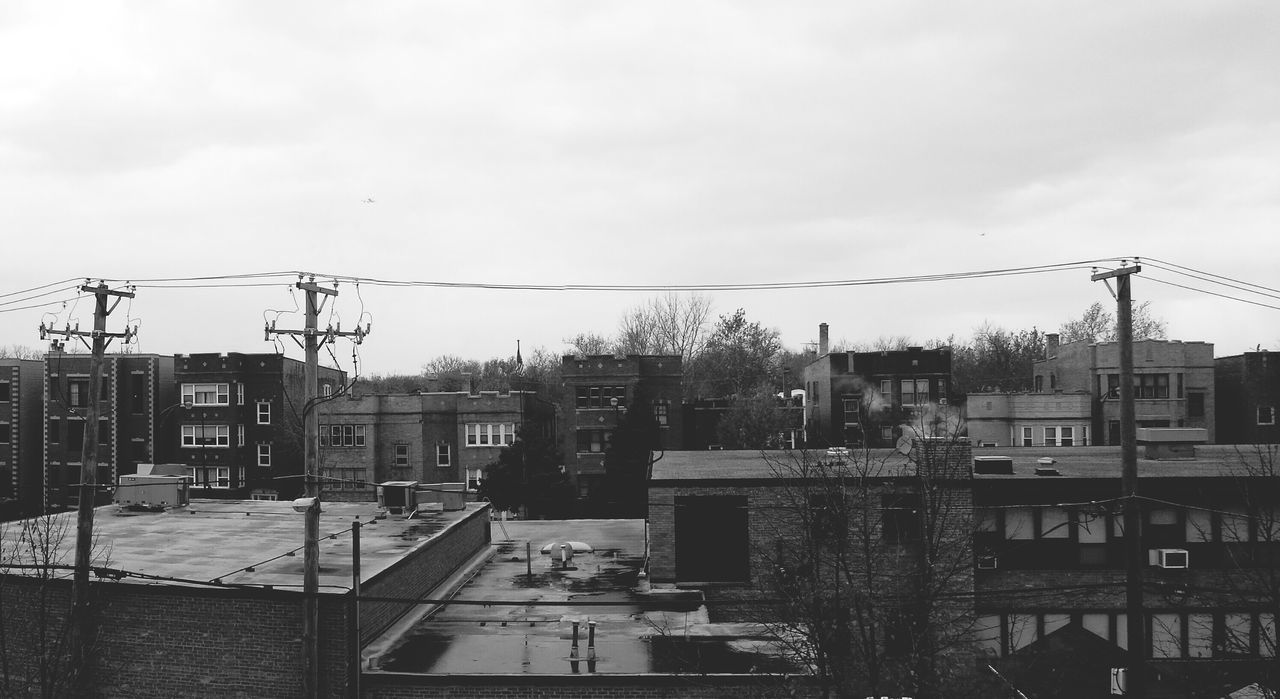 building exterior, architecture, built structure, city, sky, residential building, residential structure, house, residential district, building, crane - construction machinery, construction site, cityscape, development, day, power line, outdoors, cloud - sky, electricity pylon, no people