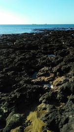 Aerial view of sea against clear blue sky