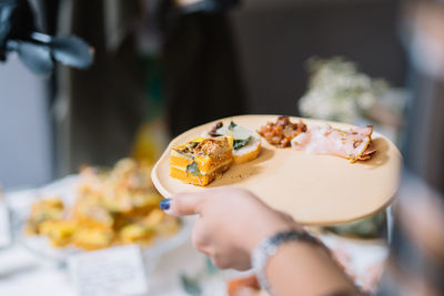 Close-up of woman holding ice cream in plate