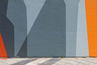 Urban scene with empty street and colorful geometrical wall