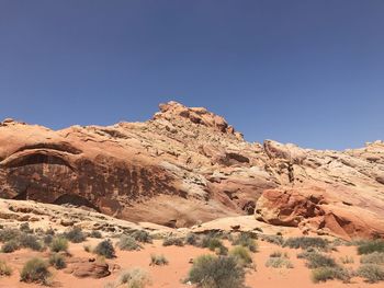 Scenic view of desert against clear blue sky