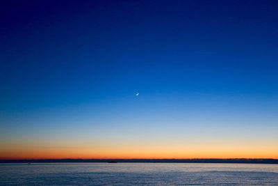 Scenic view of sea against clear sky at night