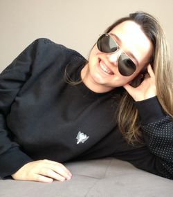 Close-up portrait of a smiling young woman sitting at home