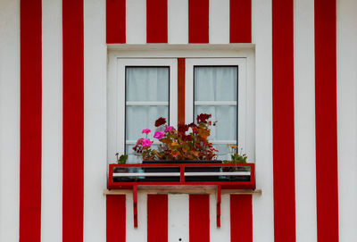 Typical colourful houses with red and white stripes in costa nova - aveiro against sky