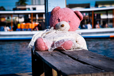 Close-up of toy boat on pier against canal