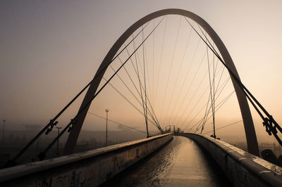 View of suspension bridge against sky during sunset