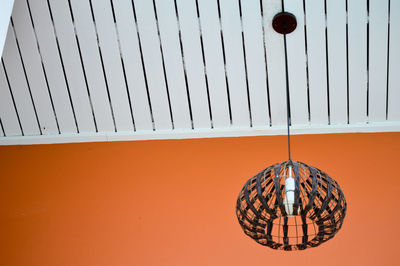 Low angle view of lighting equipment hanging on wall