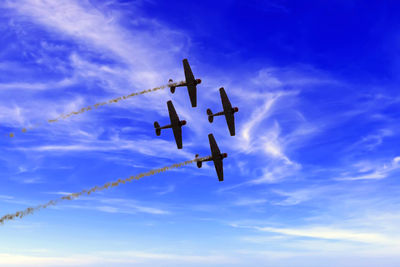 Low angle view of airplane against cloudy sky