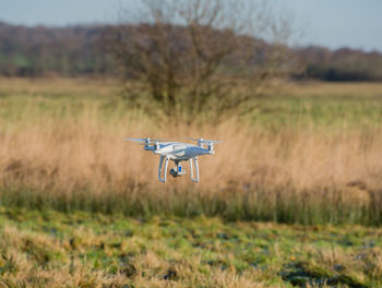 Drone flying over field