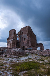 Low angle view of old ruin building against sky