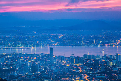 Aerial view of illuminated city buildings at night