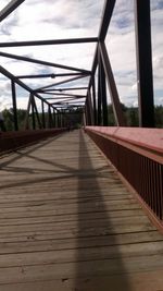 Bridge over river against cloudy sky