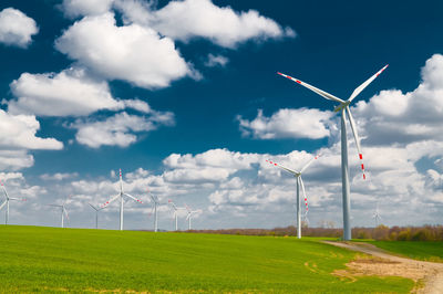 Windmill on field against sky