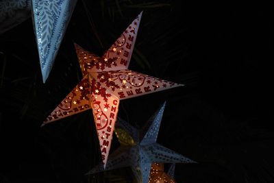 Low angle view of illuminated christmas lights at night