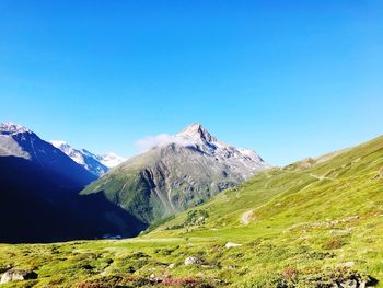 Scenic view of mountains against clear blue sky