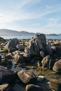 Rocks on beach against sky