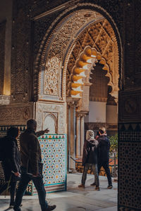 Rear view of people in temple outside building