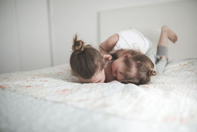 Sister's girls play and hug, emotions. concept childhood and related relationships, lifestyle 