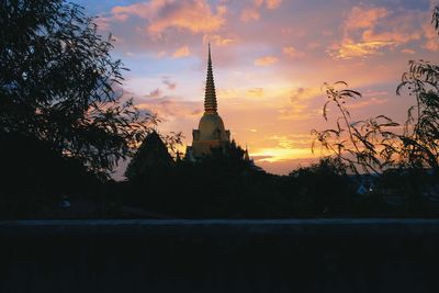 Silhouette of temple building against sky during sunset