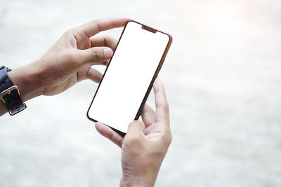 Close-up of hand holding mobile phone