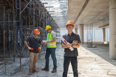 Rear view of man standing against building